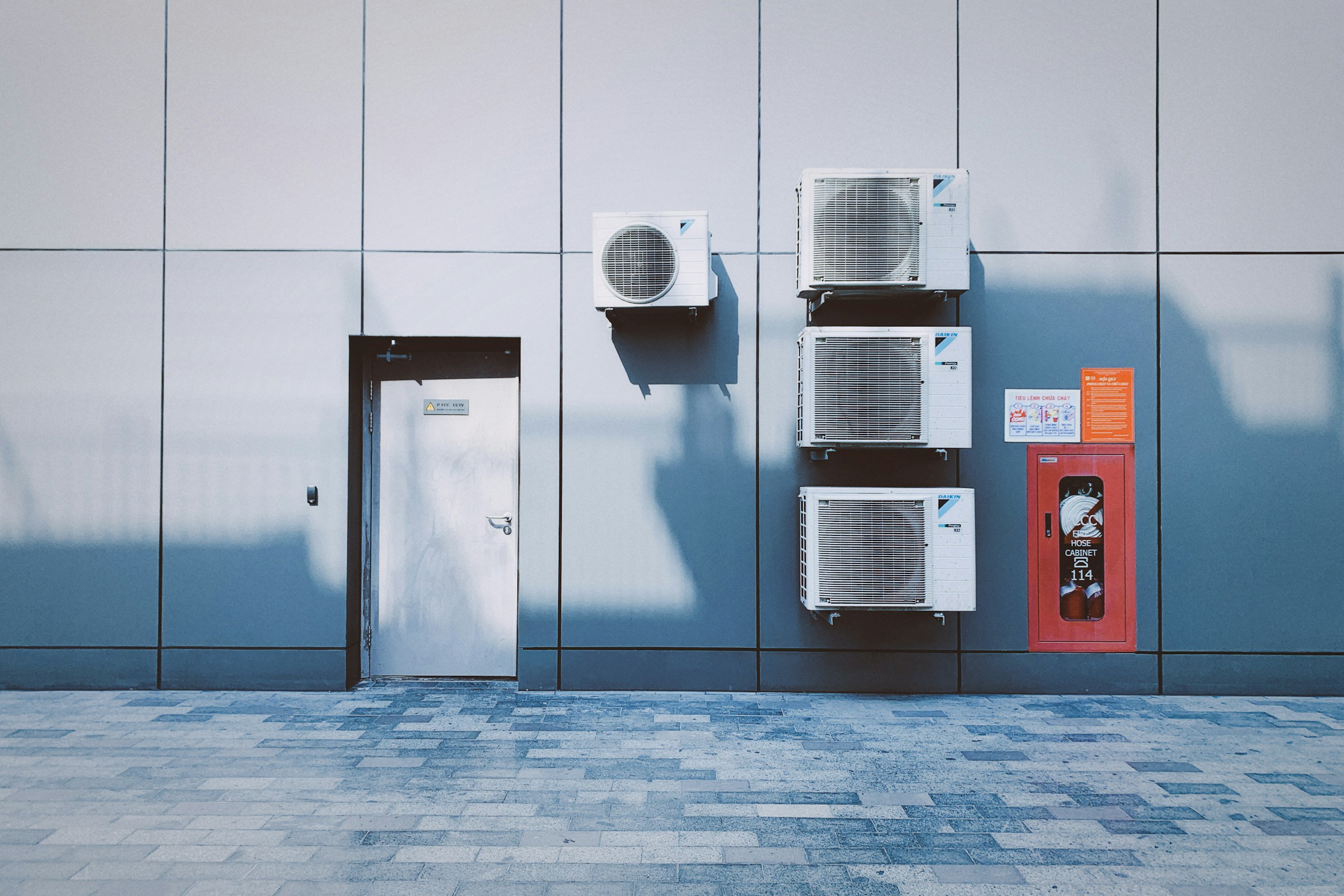 Row of commercial condenser units mounted on a building exterior